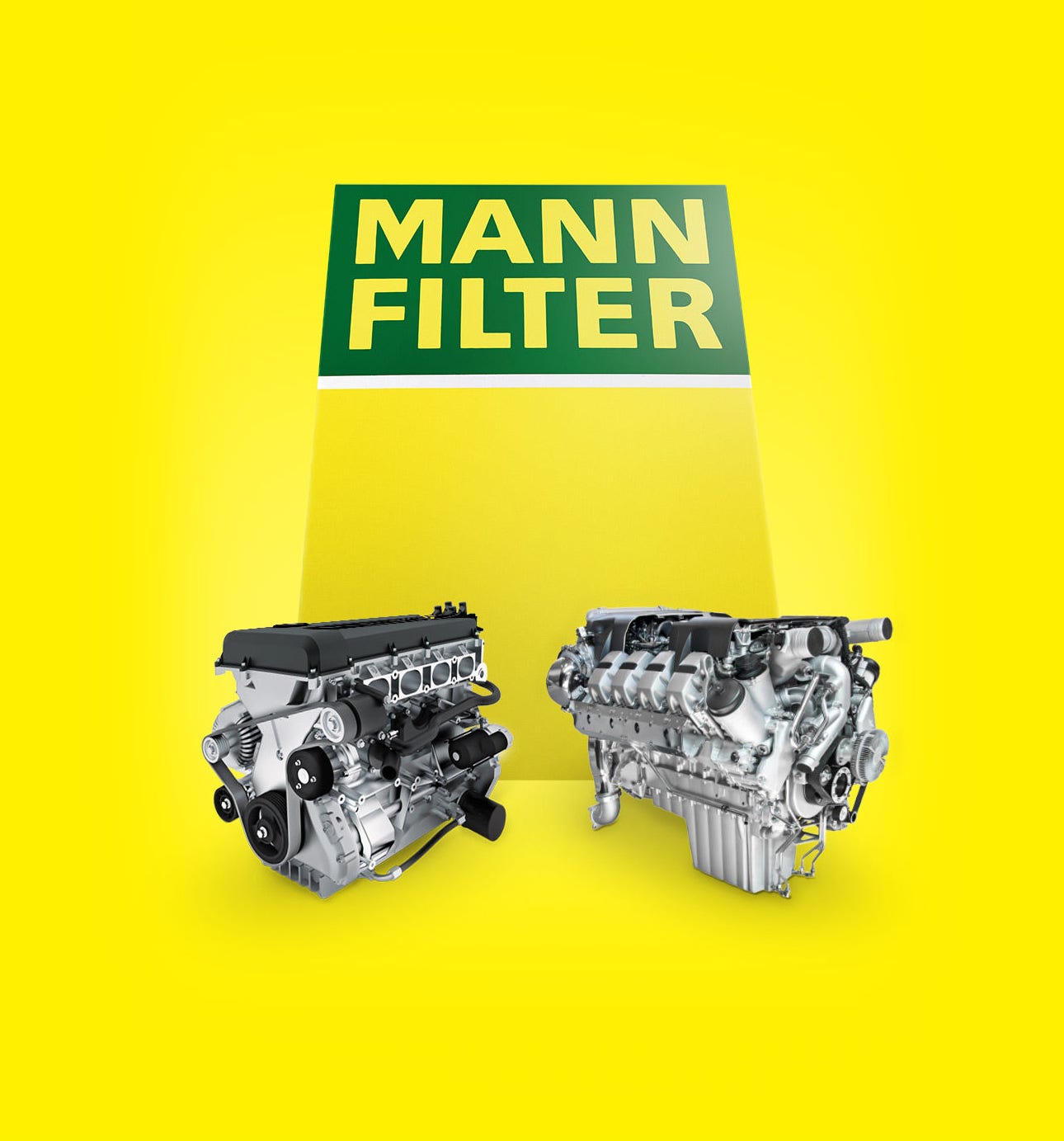 Two industrial engines with MANN-FILTER products in front of a big yellow-green MANN-FILTER box
