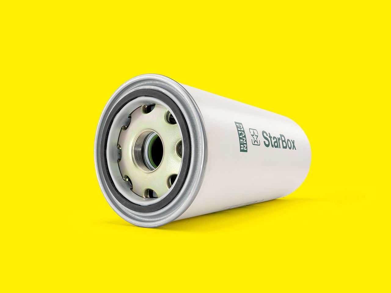 A white and silver air oil separator for compressors and vacuum pumps on a bright yellow background