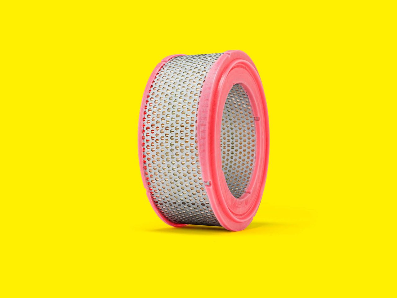 A round cabin air filter with a pink and white design for forklifts and telehandlers