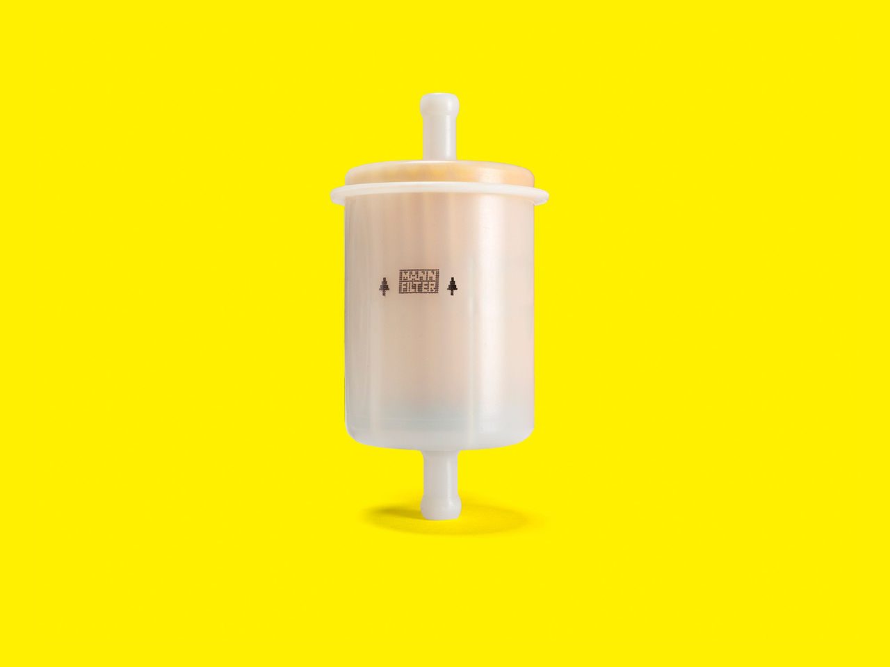 A white cylindrical fuel filter for gensets with a vertical design displayed on a yellow background