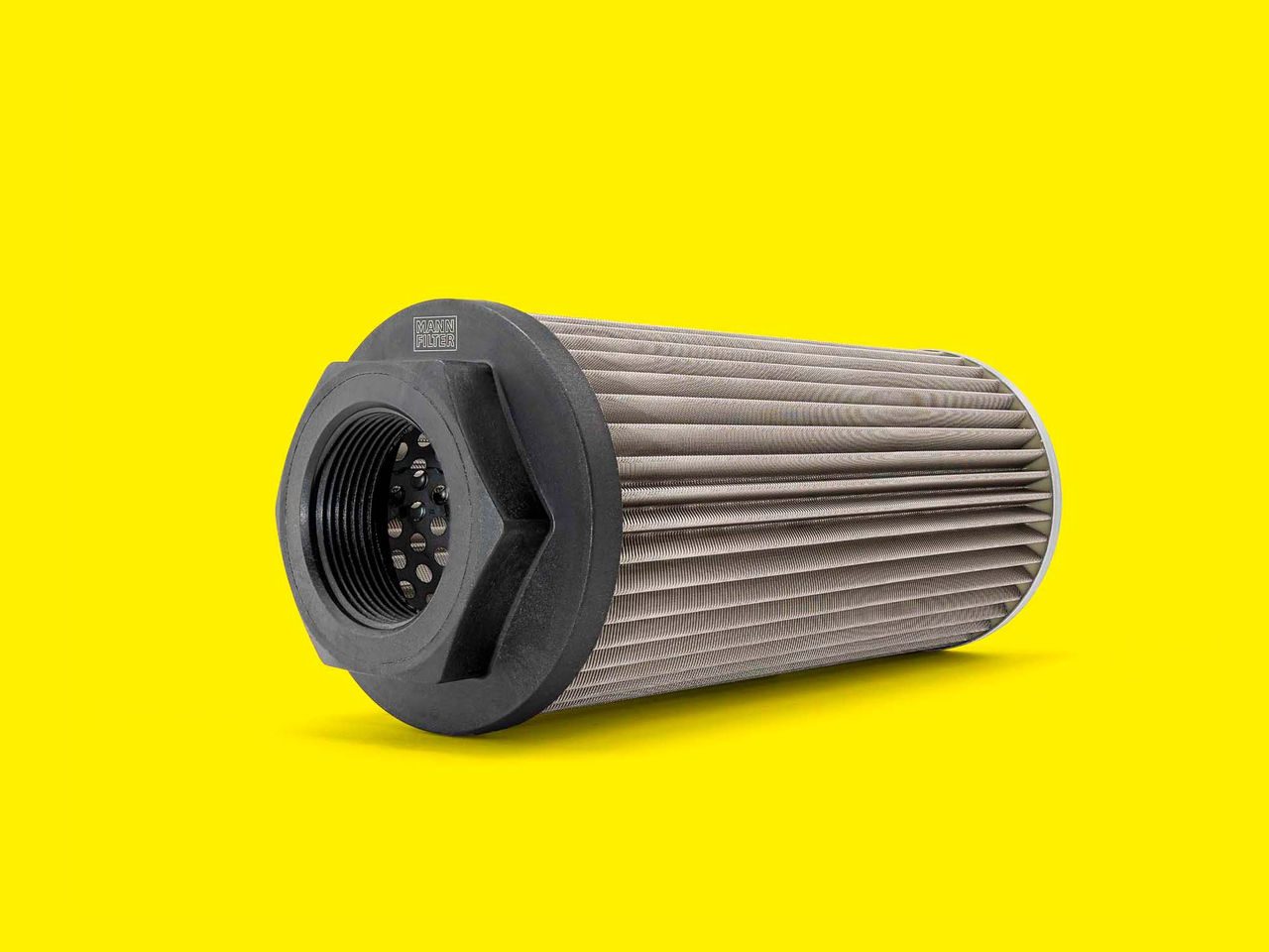 A pleated cylindrical hydraulic filter for telehandlers and forklifts on a yellow background