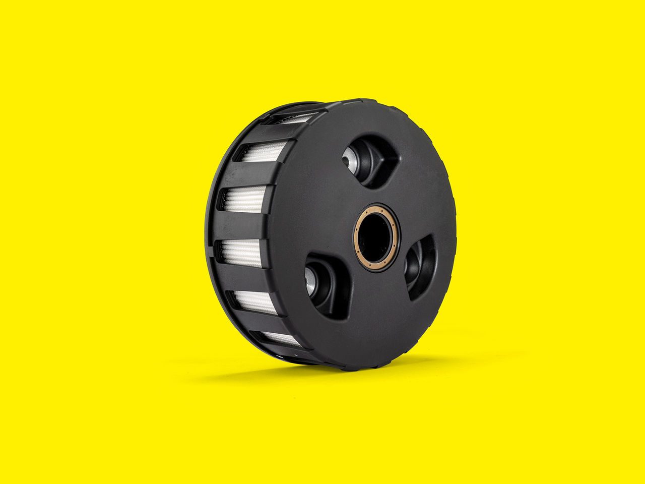 Black MANN-FILTER air oil separator with visible pleated elements on a bright yellow background