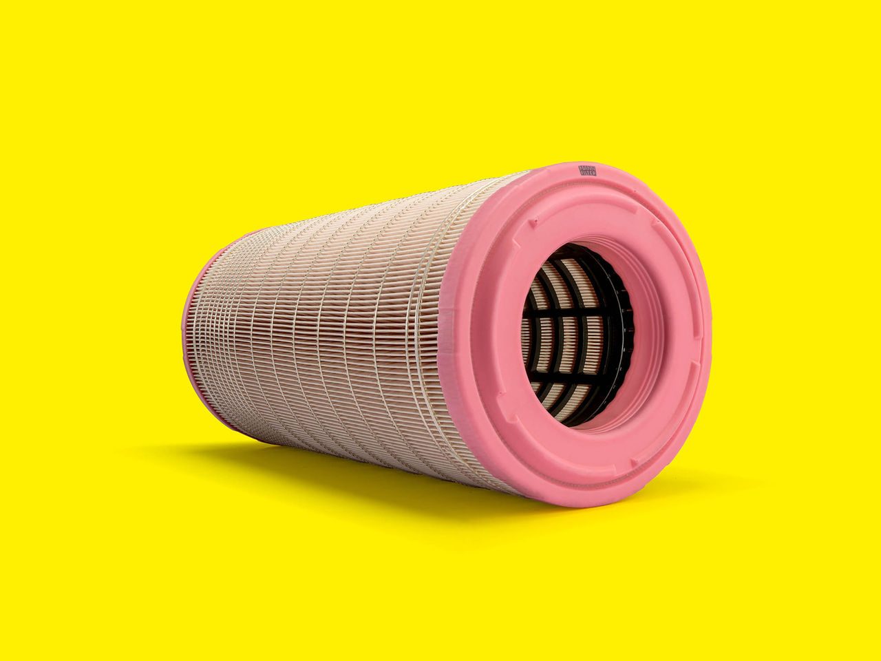 Cylindrical MANN-FILTER engine air filter with pink caps, ready to install and built to last