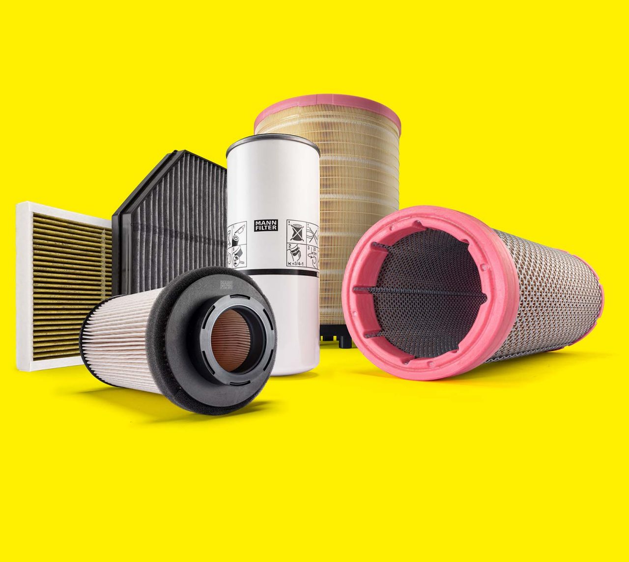 MANN-FILTER truck and bus filters, including air and cabin filters, displayed on a yellow background